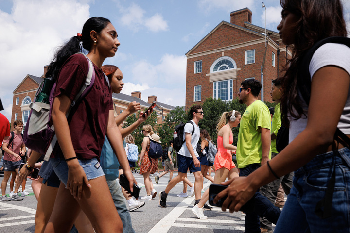 Students cross a busy crosswalk a the University of Georgia on the first day of classes.