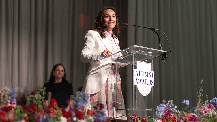 Lucy Pinto speaks at a podium