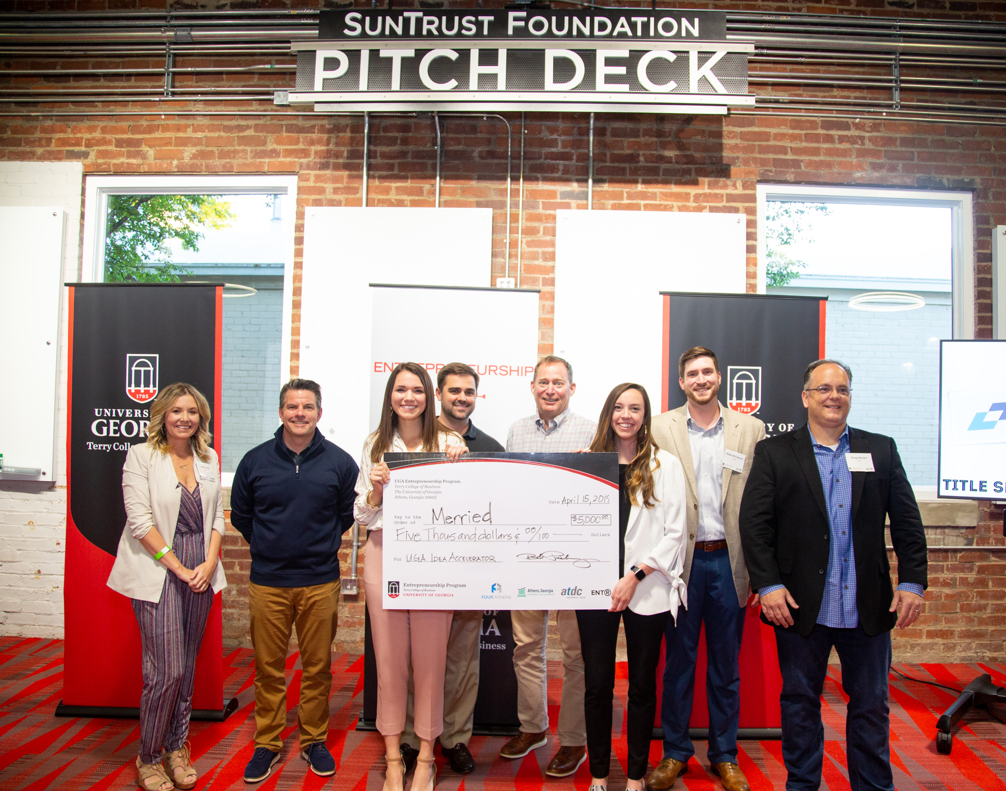 Merried app creators Megan Staebell and Emily Ruff pose with judges and their first-prize check at the Spring 2019 Idea Accelerator Demo Day.