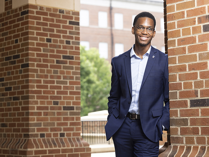Kevin Nwogu leans against a brick column at Terry