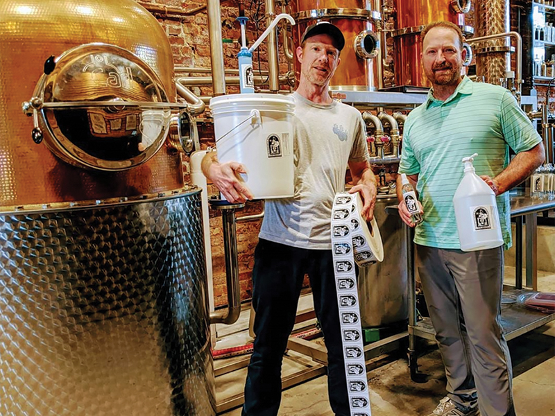 Jeff and Craig Moore of Old Fourth Distillery with a batch of their sanitizer.