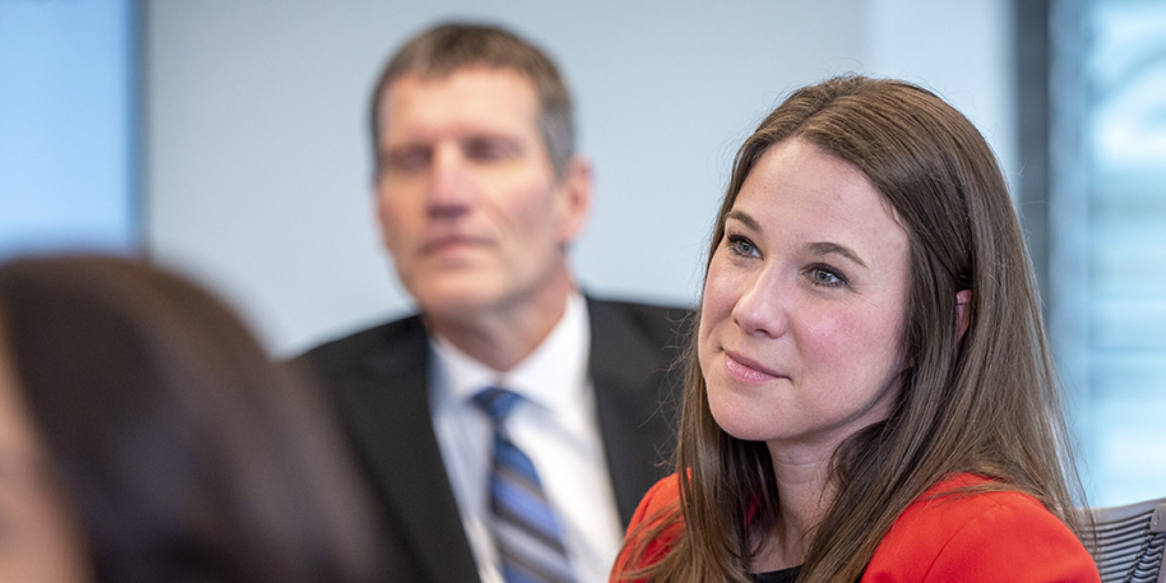 Female student looks on in a classroom.