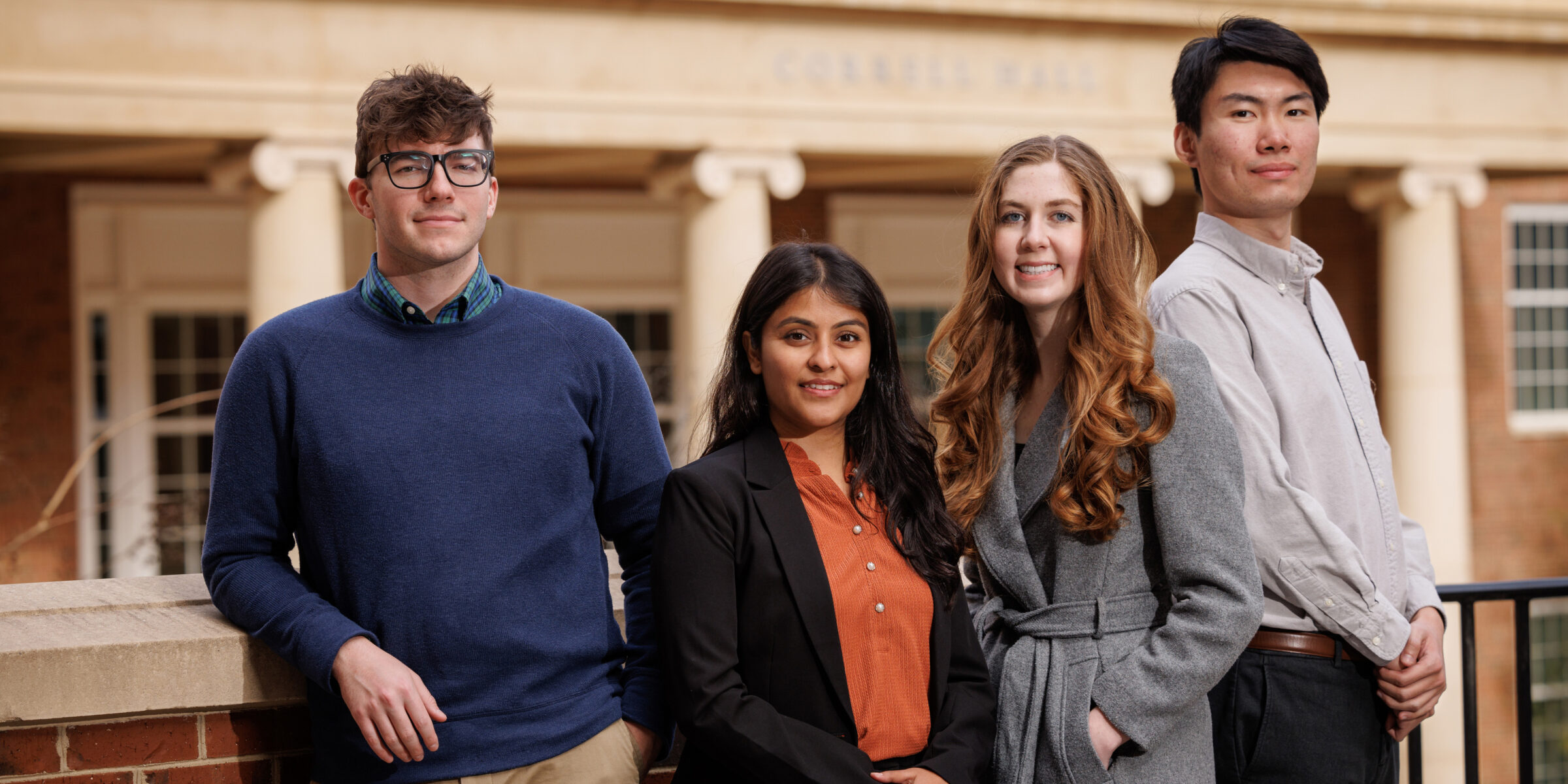 PhD Students posing in front of Correll Hall