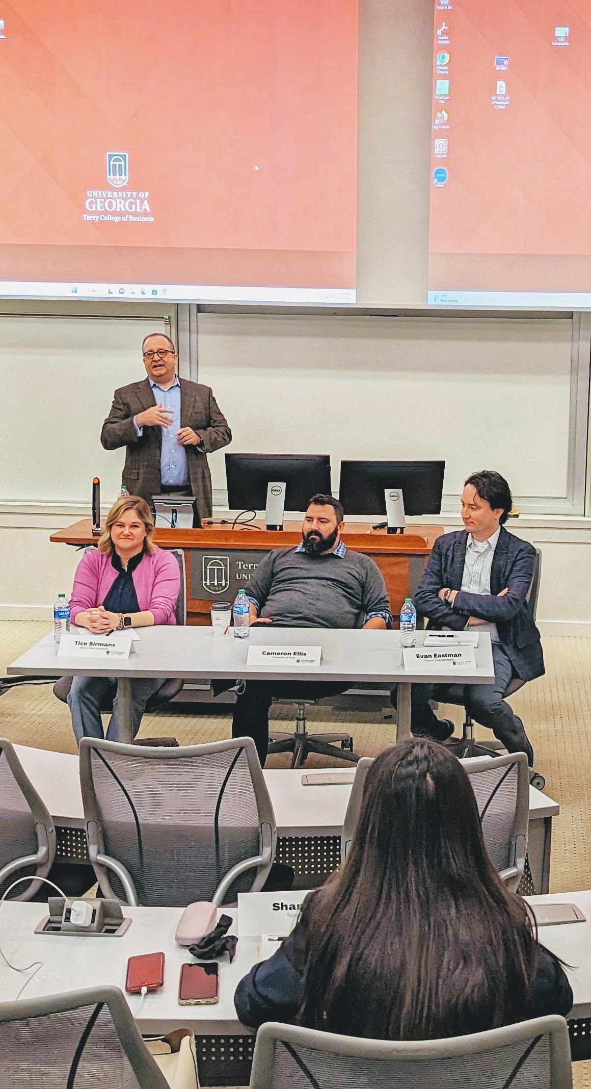 Three speakers to the audience in a BLC classroom during a Risk Management & Insurance Symposium.