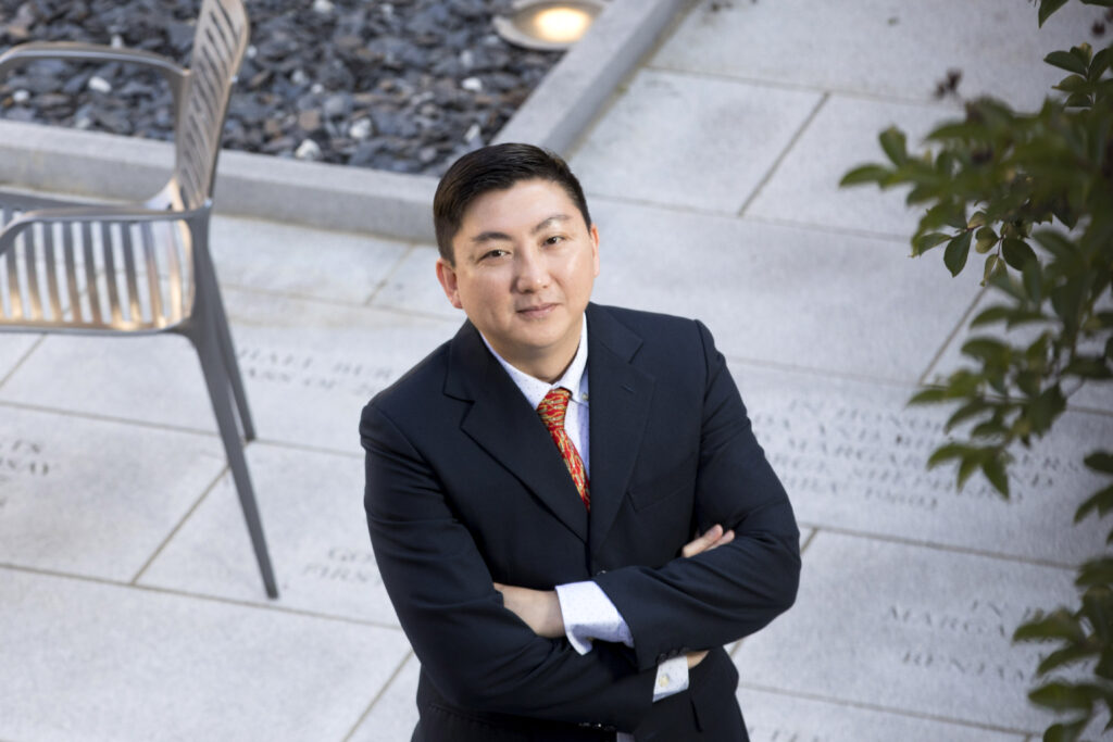 Son Lam poses for a photo with his arms crossed at the Business Learning Community