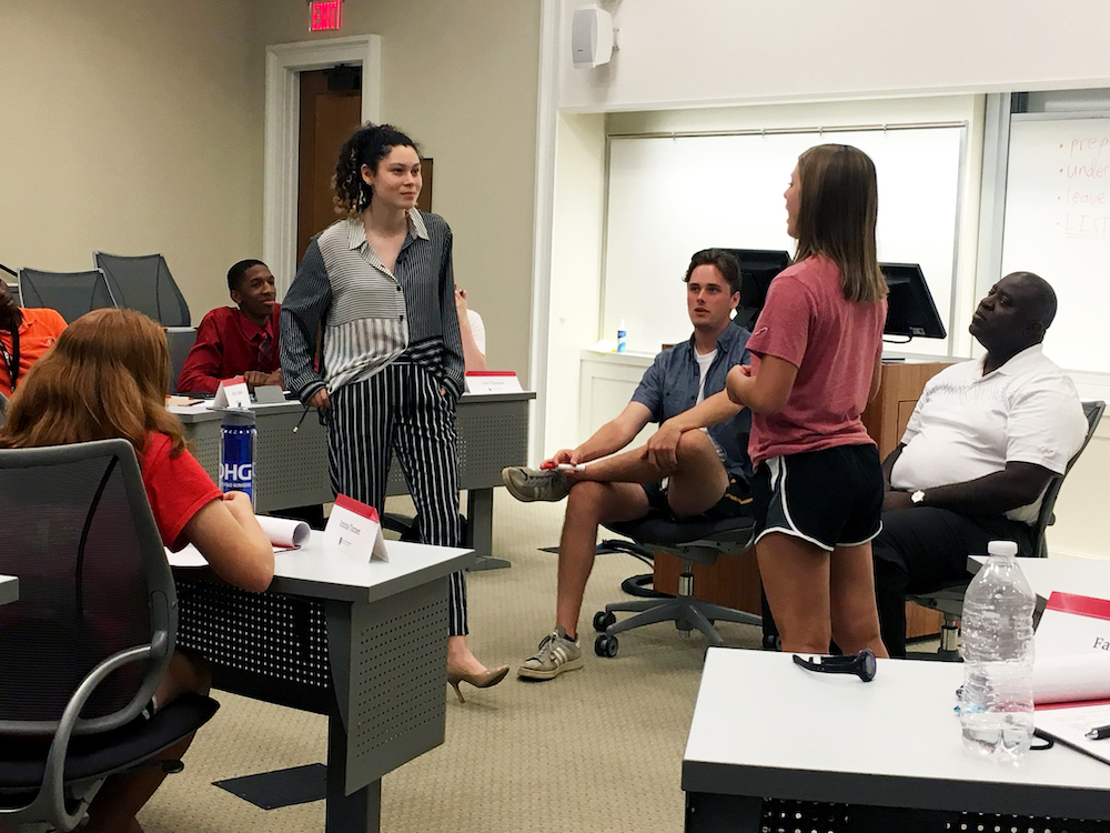 High school students Alexis Smith and Faith Wagner put their skills to the test in a mock negotiation during the Terry Business Academy