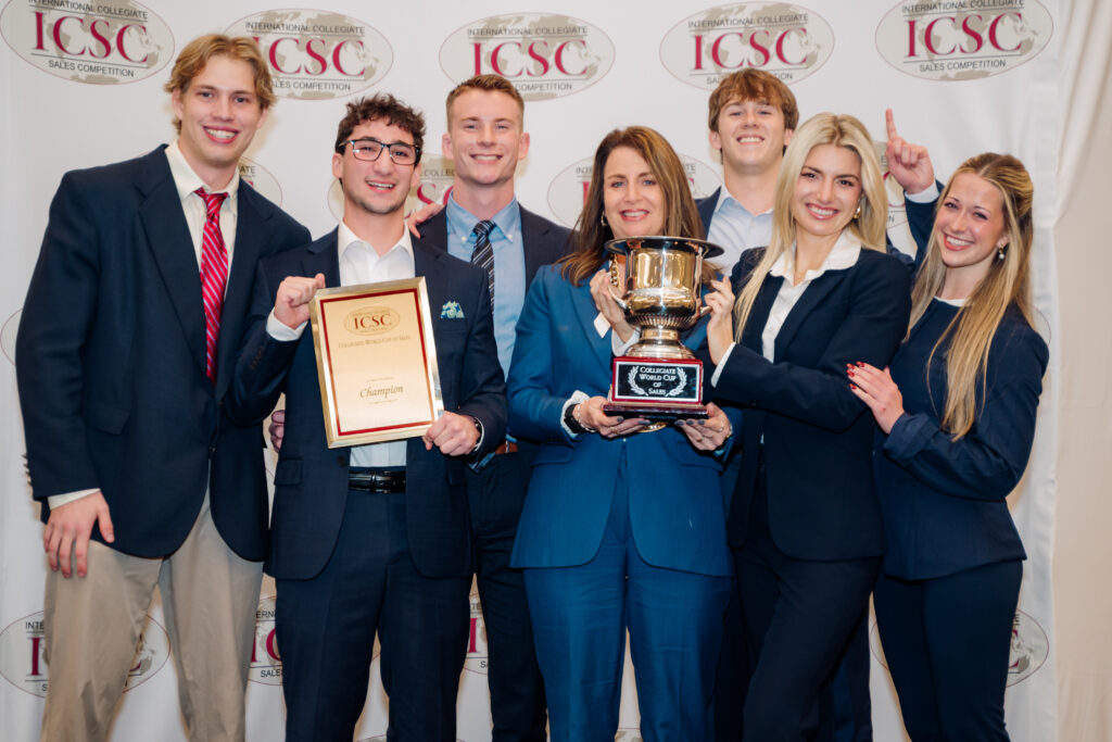 Terry professional sales students pose with trophies and plaques at the International Collegiate Sales Competition.