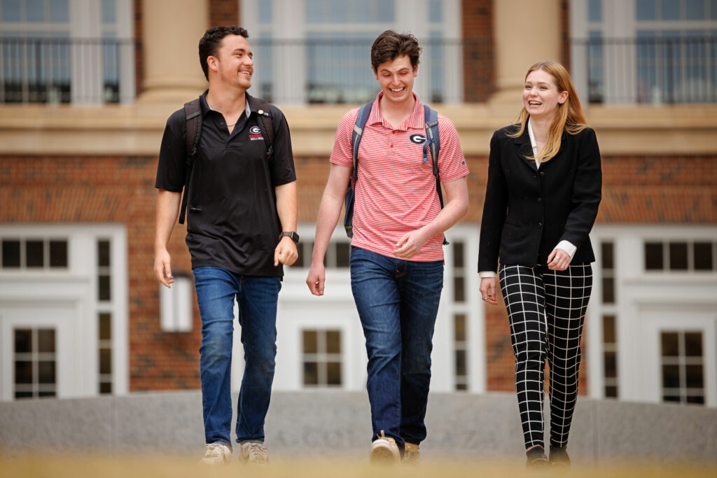 three students walking in Coca-Cola Plaza