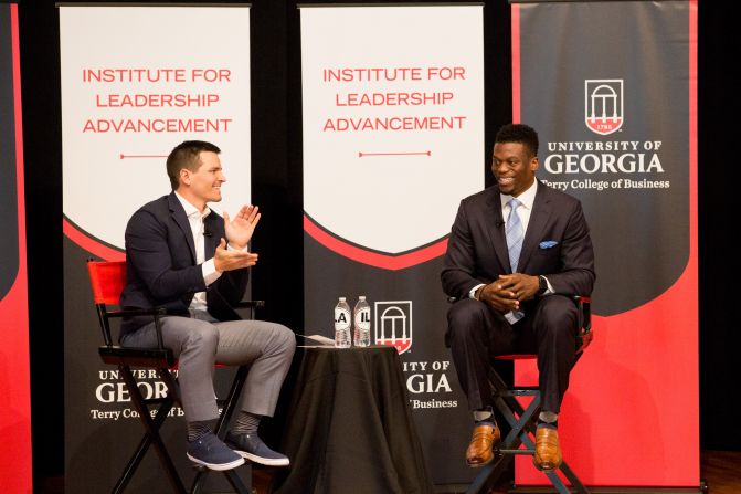From right: Pro football player and author Benjamin Watson (BBA ’03) talks with Michael MacDonald (BBA ’10)