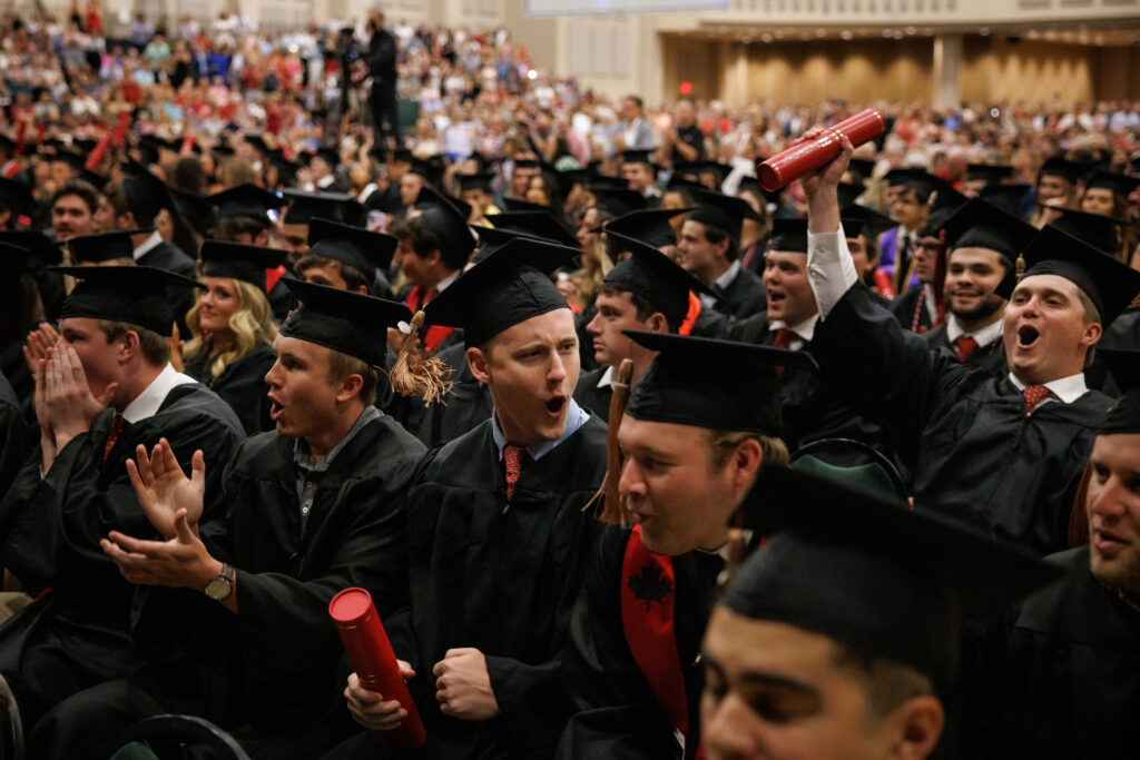 Terry College of Business students celebrate graduation in their caps and gowns.